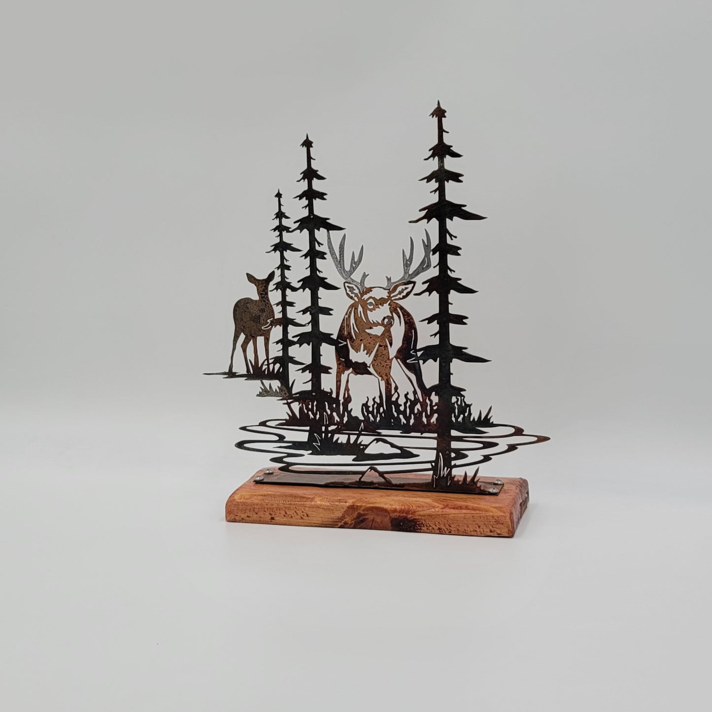Deer Shelf Sitter measures 11.5" H x 10.5 W" x 18 gauge. The wood piece measures 9" L x 6.5" W x 1/2" Thick. The yew wood has been sanded and varathaned. The metal scene will come with the piece of yew wood unattached, but it can be easily assembled using a screwdriver and the 4 screws we will provide. Four Color Options Available; Colored-Rustic, Flat Black, Hammer Tone, Bare Metal. Sprayed with several coats of Varathane.