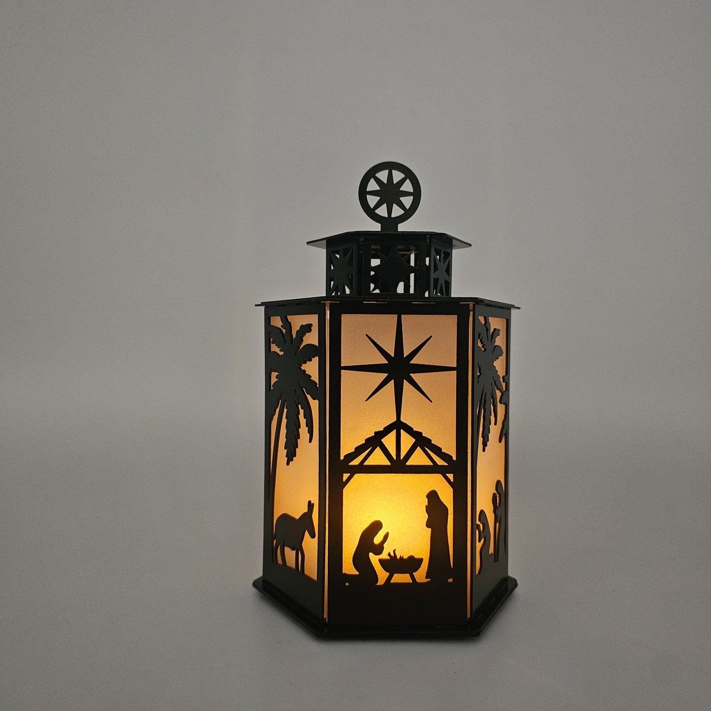 Nativity Scene Metal Lantern. Two colors available: Powder coat gloss Black, Colored-Rustic. Measures 9 Inches High x 6 Inches wide. Battery operated. On off switch. Battery lasts up 70 hrs.