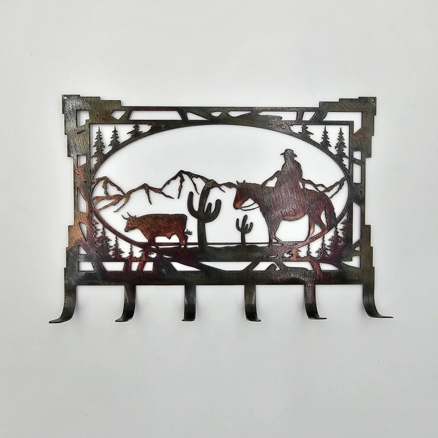 Cowboy Bull Cactus Mountains Key Rack measures 8" W x 5.5" H. 6 Hooks for keys. Hangs via two nails not inlcuded. Sprayed with several coats of Varathane.