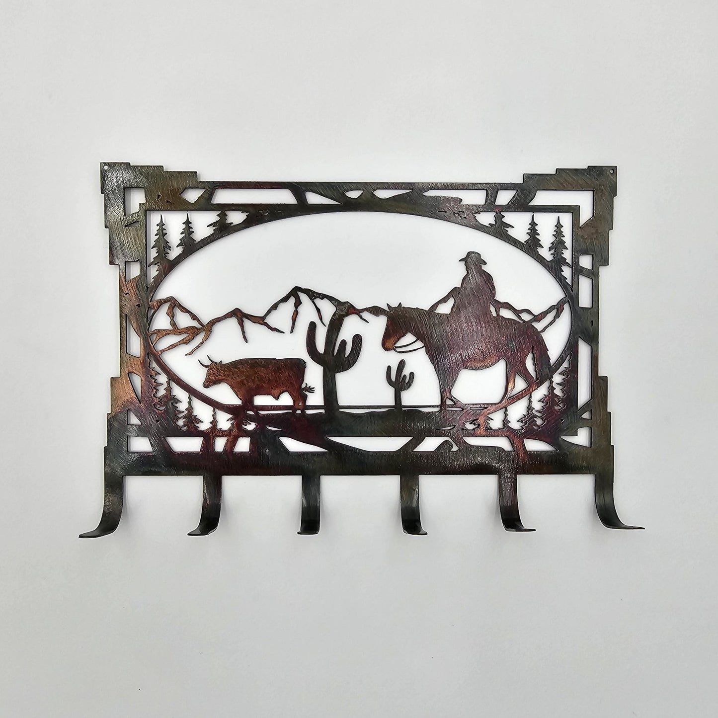 Southwest Oval Cowboy Key Rack measures 8" W x 5.5" H. 6 Hooks for Keys. Sprayed with several coats of Varathane.