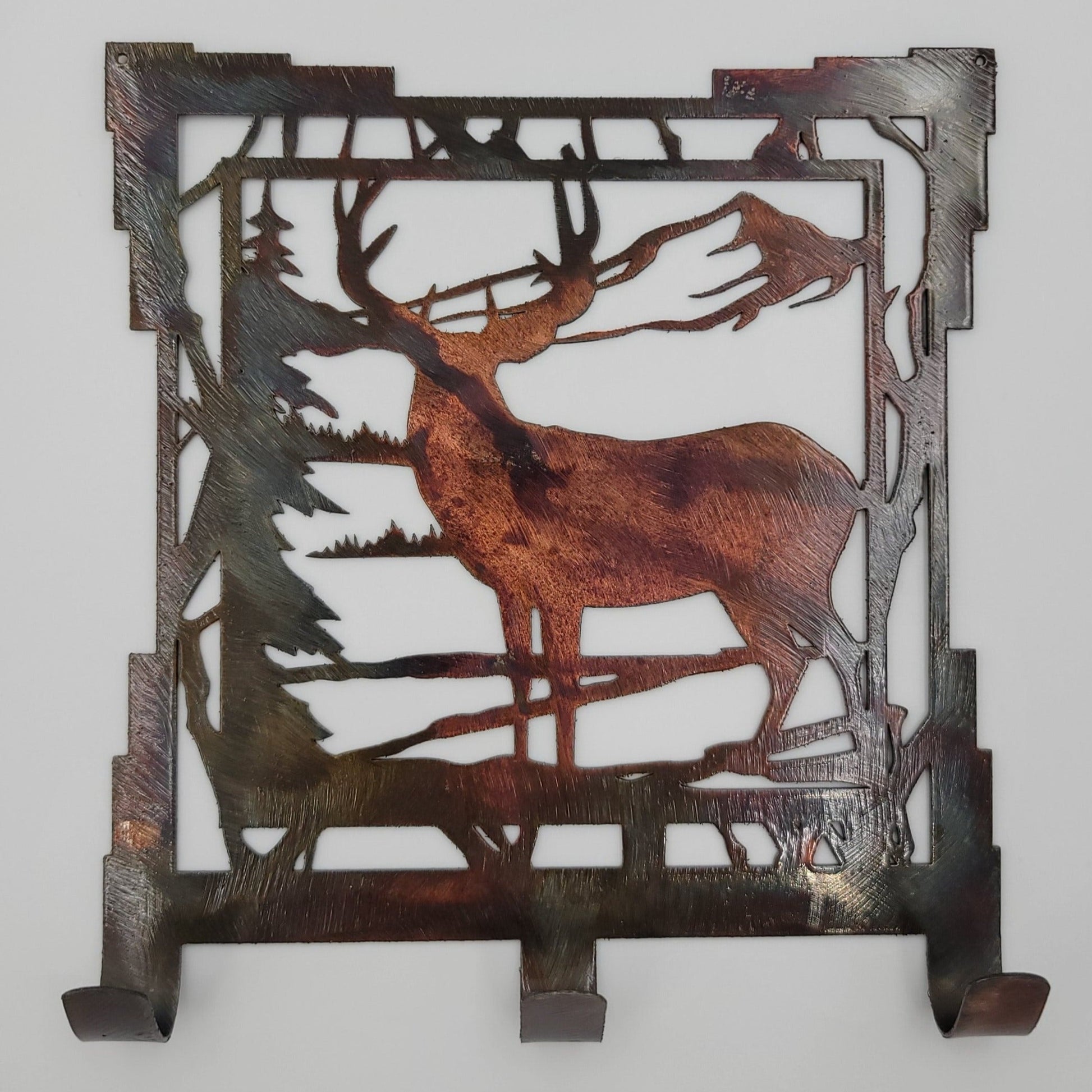 This Southwest Rustic Metal Deer Scene Key Rack is 6.25" wide x 7" high with an 18-gauge thickness. Three hooks allow for easy storage of keys, while two holes in the top corners enable easy hanging with two nails (not included). Available in four colors  Colored=Rustic, Black, Hammer Tone, Bare Metal