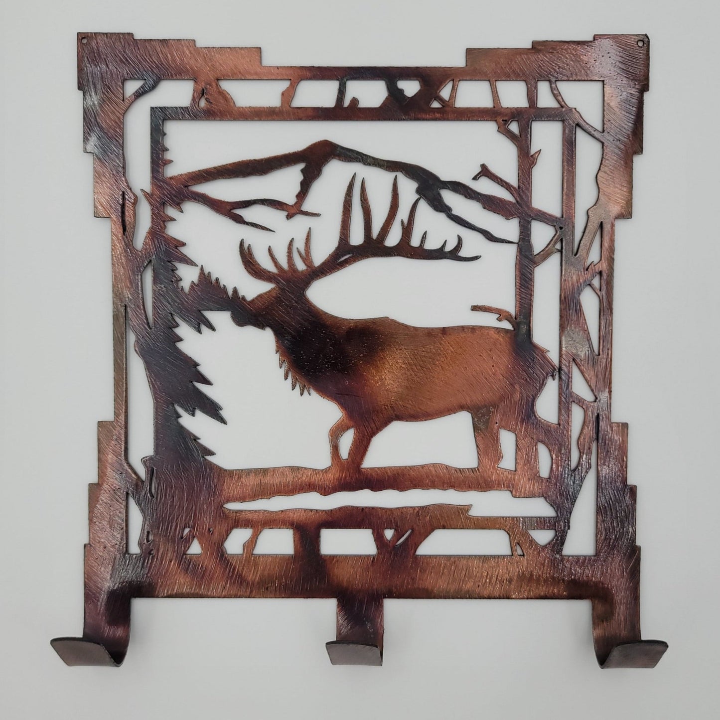 Southwest Elk Metal Key Rack. Measures 6.25 inches wide x 7 inches high x 18-gauge Thick. Has three hooks for keys. Available in four colors; colored-rustic, Black, Hammer Tone, Bare Metal. Holes in top corners for easy hanging. Hangs via two nails, not included. Protected with a thick layer of varathane. We do custom orders, so if you'd like this item larger contact us prior to ordering. Gift wrapping available at checkout.