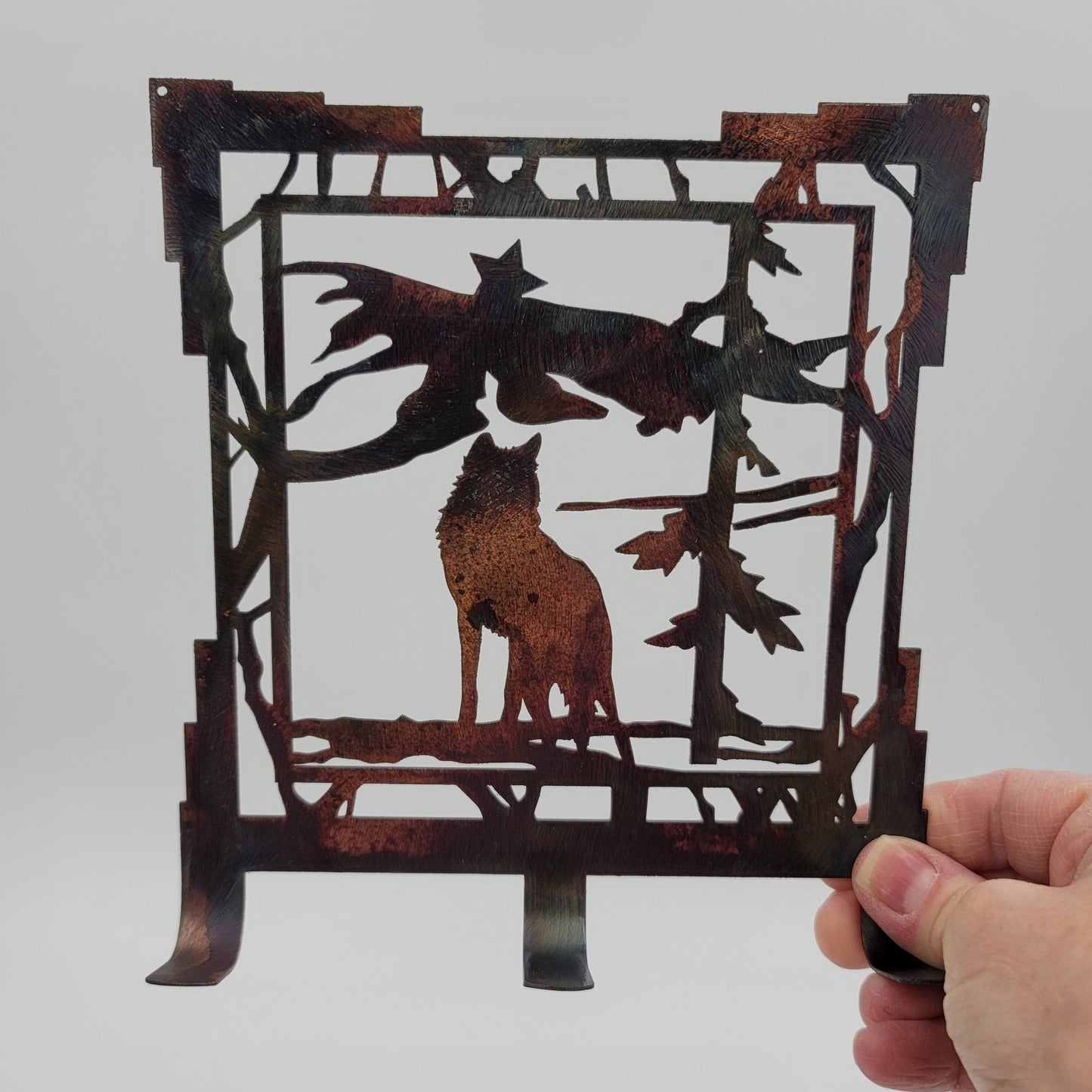 Rustic Metal Wolf Key Rack measures 6.25 inches wide x 7 inches high x 18-gauge Thick. Has three hooks for hanging keys. Holes in top corners for easy hanging. Hangs via two nails, not included. Available in four colors; Colored-Rustic, Black, Hammer Tone, Bare Metal. This is the colored version. Sprayed with a thick layer of Varathane for protection. Gift Wrapping available at checkout.