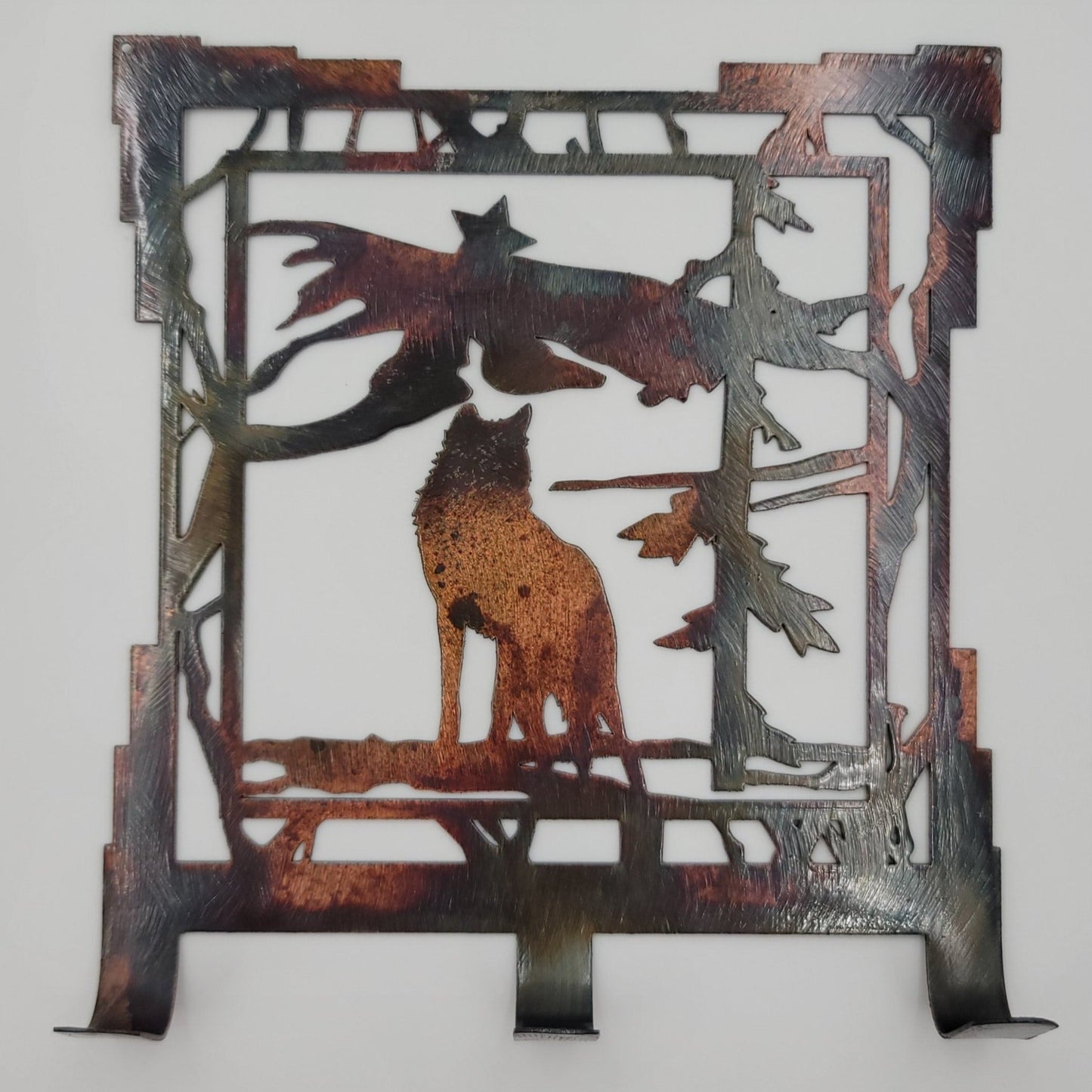 Southwest Wolf Key Rack. Measures 6.25 inches wide x 7 inches high x 18 gauge thick. Three hooks for keys. Has holes in top corners for easy hanging. Hangs via two nails not included. Available in four colors; Colored-Rustic, Black, Hammer Tone, Bare Metal. Sprayed with a thick layer of Varathane for protection.