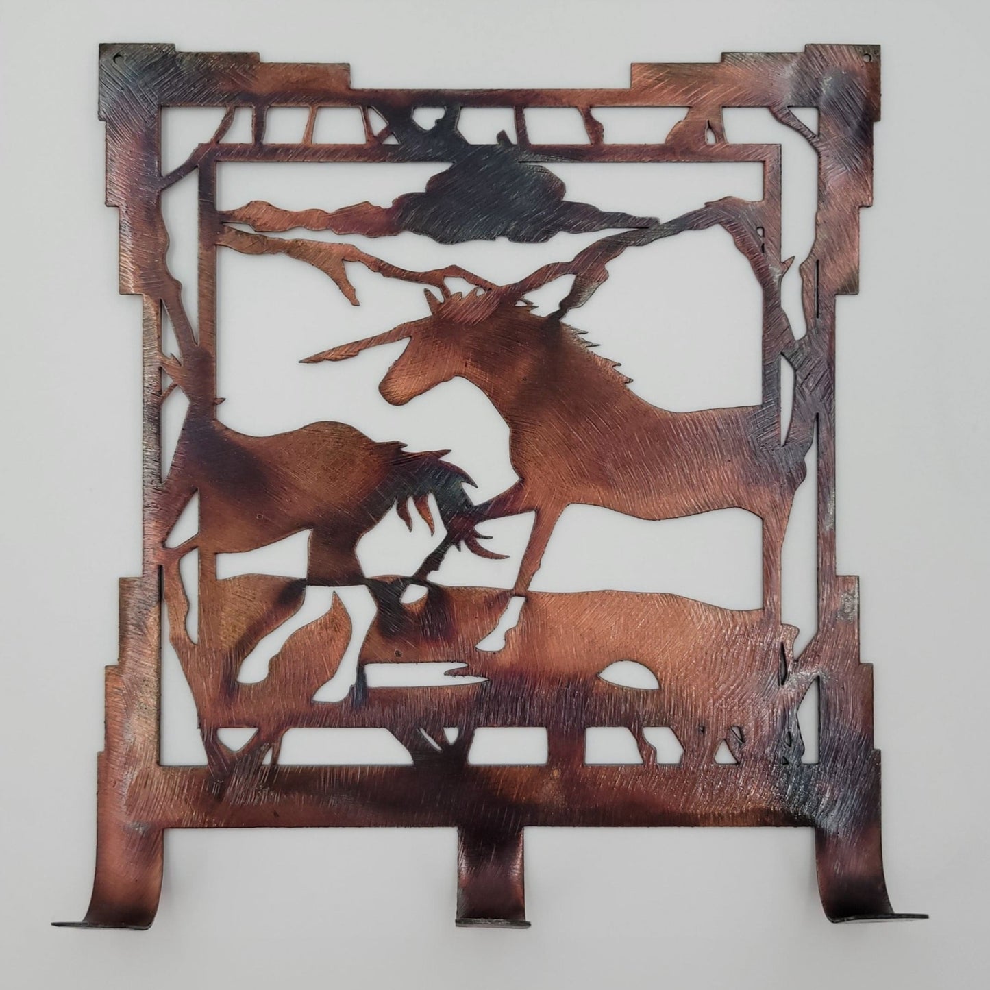 Southwest Two Horses Rustic Metal Key Rack. Measures 6.25 inches wide x 7 inches high x 18 gauge thick. Has three hooks for hanging. Two holes in top corners to hang. Hangs via two nails, not included. Available in 4 colors; Colored-Rustic, Black, Hammer Tone, Bare Metal. Sprayed with a thick layer of Varathane for protection.