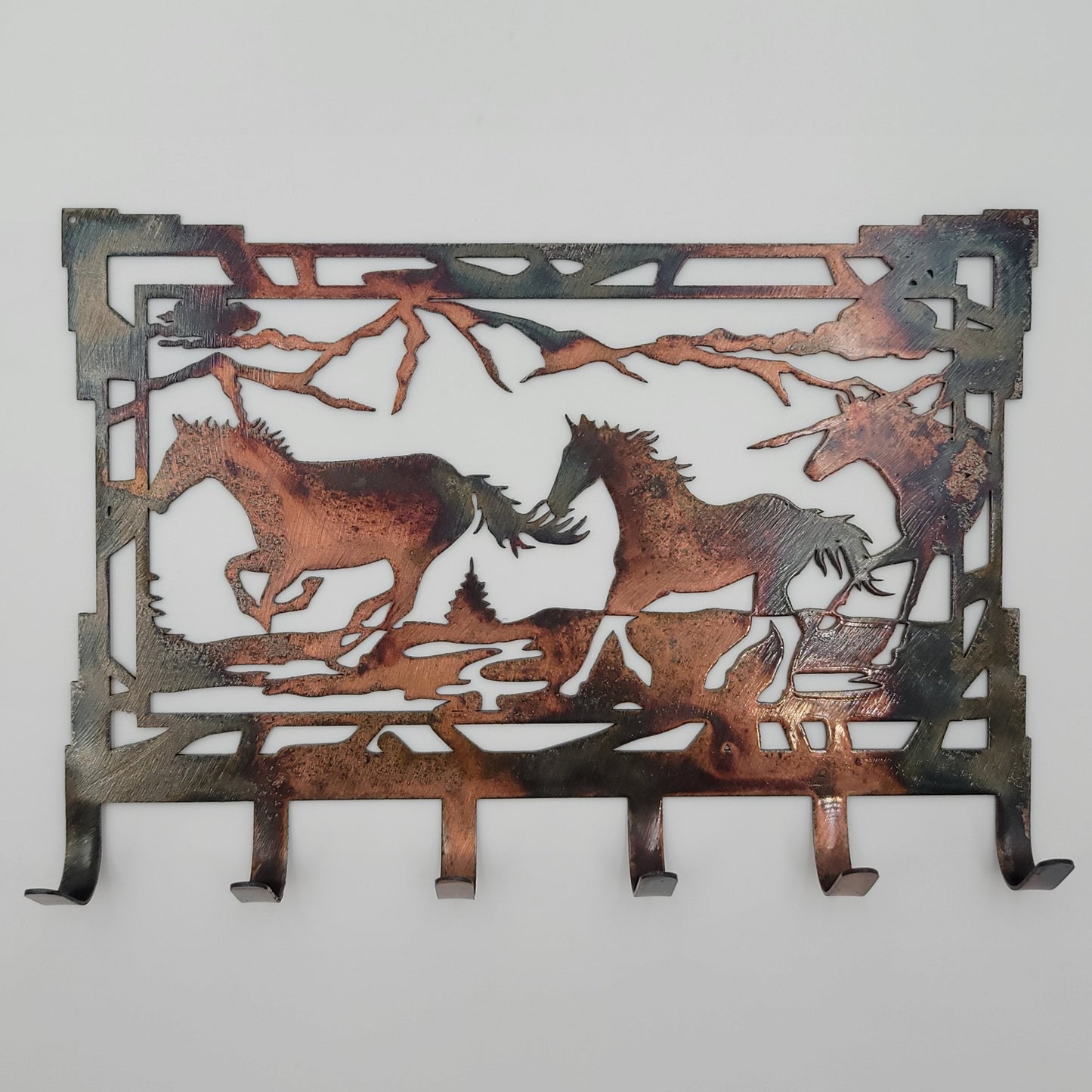 Wall Mounted Rectangular Metal Horse Key Rack features a Southwest Design, 6 hooks. Available in 4 colors; colored=rustic, black, hammer tone, bare metal. Hangs via two nails not included. Measures 8 Inches Wide x 5.25 High.