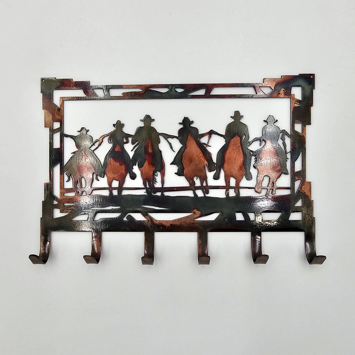 Measuring 8" Wide x 5.5" High and constructed of 18-gauge steel, key rack features 6 hooks and can be purchased in four colors: Colored-Rustic, Black, Hammer Tone, and Bare Metal. A hand-ground texture is applied to the colored-rustic version and a thick layer of Varathane is applied for protection to all versions. Colored-Rustic versions may have slight variations due to the coloring process, but we do our best to replicate what you see in the photos. Gift Wrapping available at checkout.