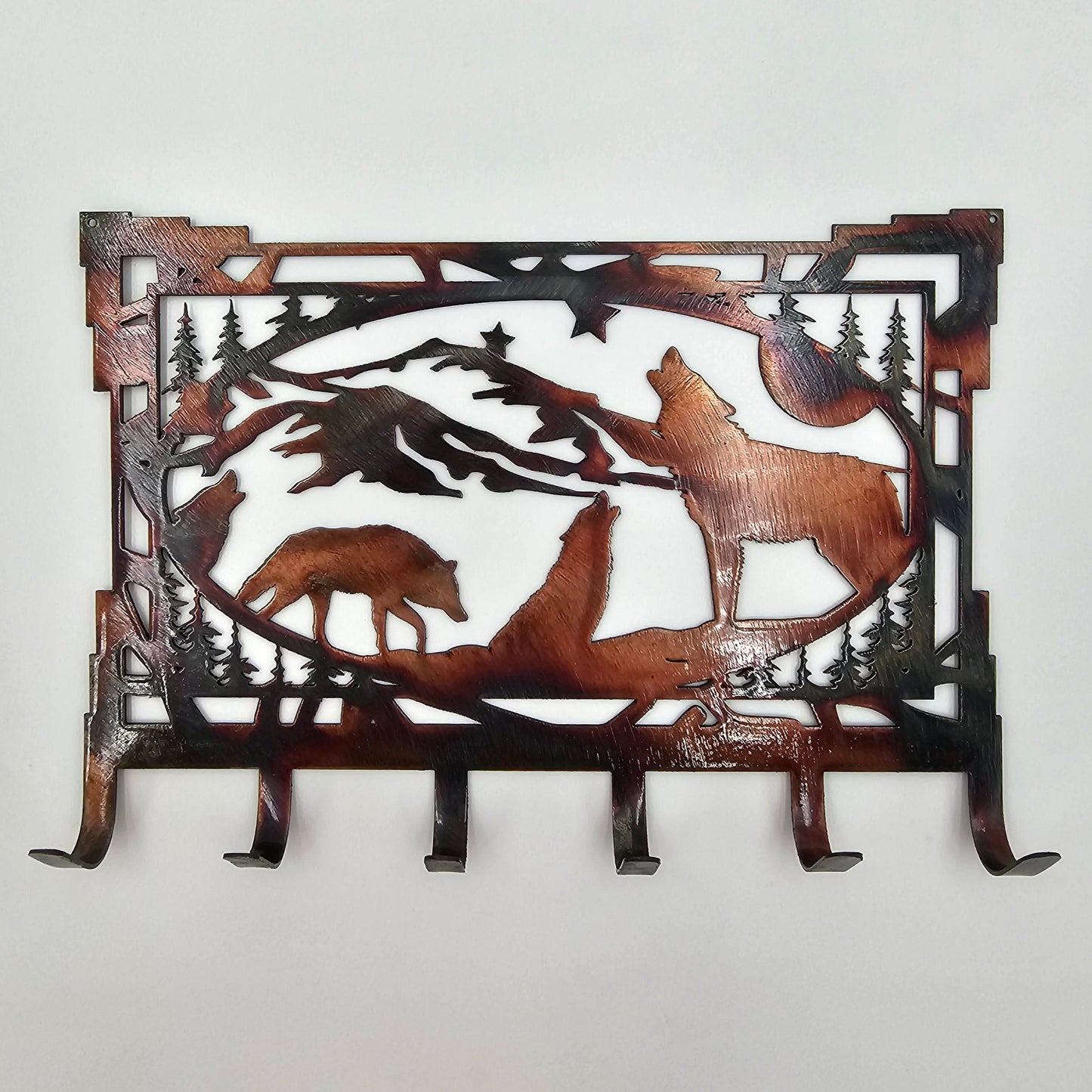 Rustic Metal Wolf Key Rack is 8" wide x 5.5" high x 18-gauge thick. Six hooks allow for easy storage of keys, while two holes in the top corners enable easy hanging with two nails (not included). Available in four colors - Colored-Rustic, Black, Hammer Tone, and Bare Metal. This is the colored-rustic version. Coated with a thick layer of Varathane. Personalization is optional contact us prior to ordering. Gift Wrapping available at checkout.
