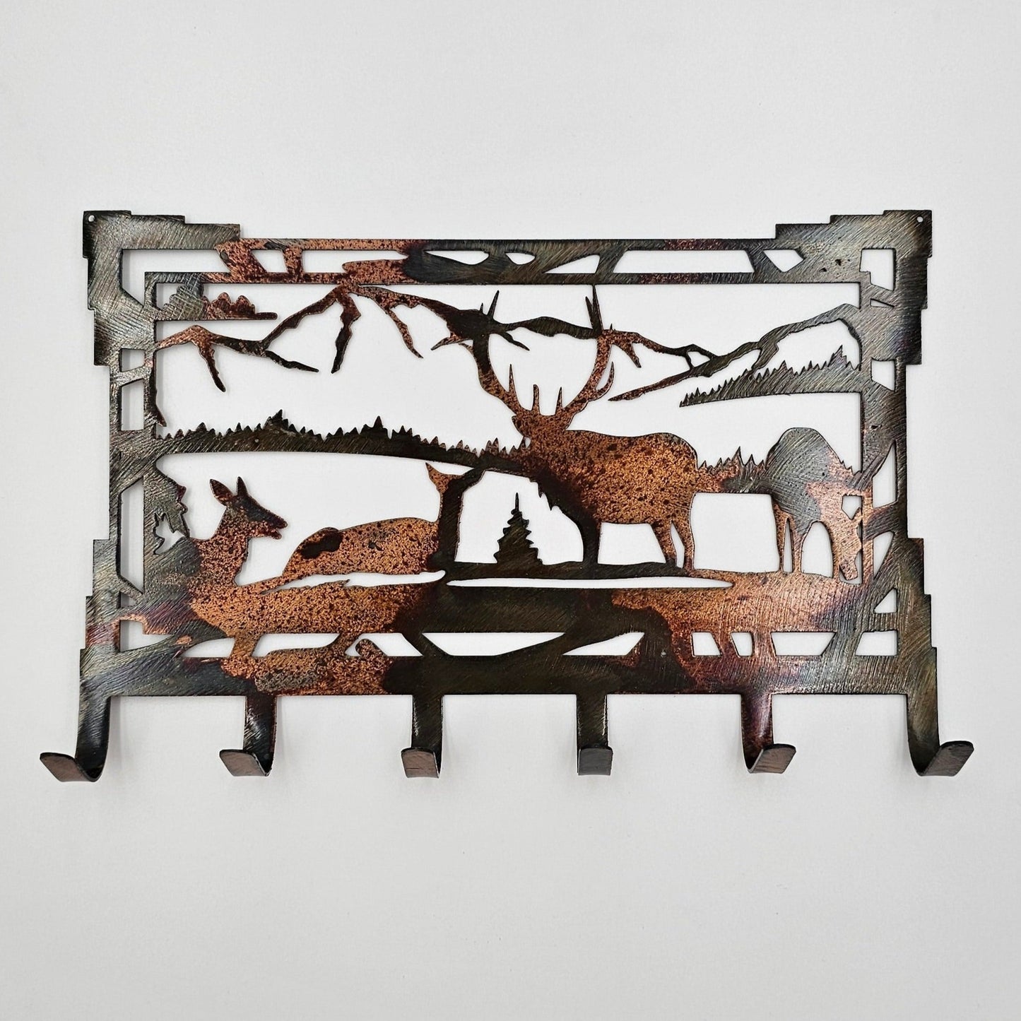 This Southwest Metal Elk Rustic Key Rack is 8" wide x 5.5" high x 18 gauge thick. Six hooks for keys. Holes in top corners for hanging. Available in four colors - Colored-Rustic, Black, Hammer Tone, and Bare Metal. Each piece is coated with a thick layer of Varathane. Personalization is optional. Hangs via two nails.