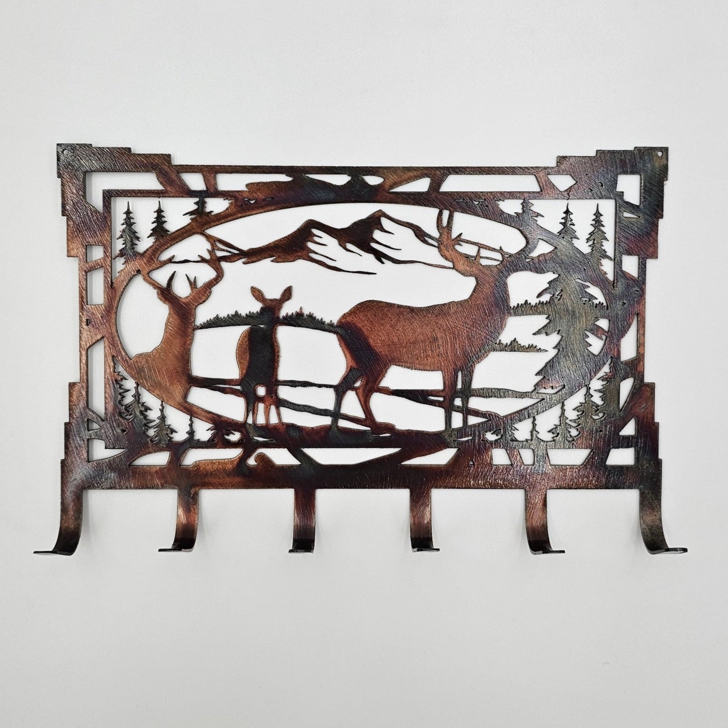 Rustic Metal Deer Key Holder. Measures 8" Wide x 5.5" High x 18 gauge Thick. Has 6 hooks for keys. Available in four colors; Colored-Rustic, Black, Hammer Tone, Bare Metal. This is the colored rustic version. Sprayed with a thick coat of varathane. We can personalize our key racks by adding a name or word. Contact us prior to ordering if you'd like it personalized.