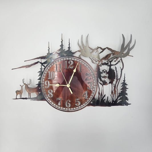 A wall clock featuring a forest scene with a large mule deer and a pair of deer, designed from silhouette of trees and animals.