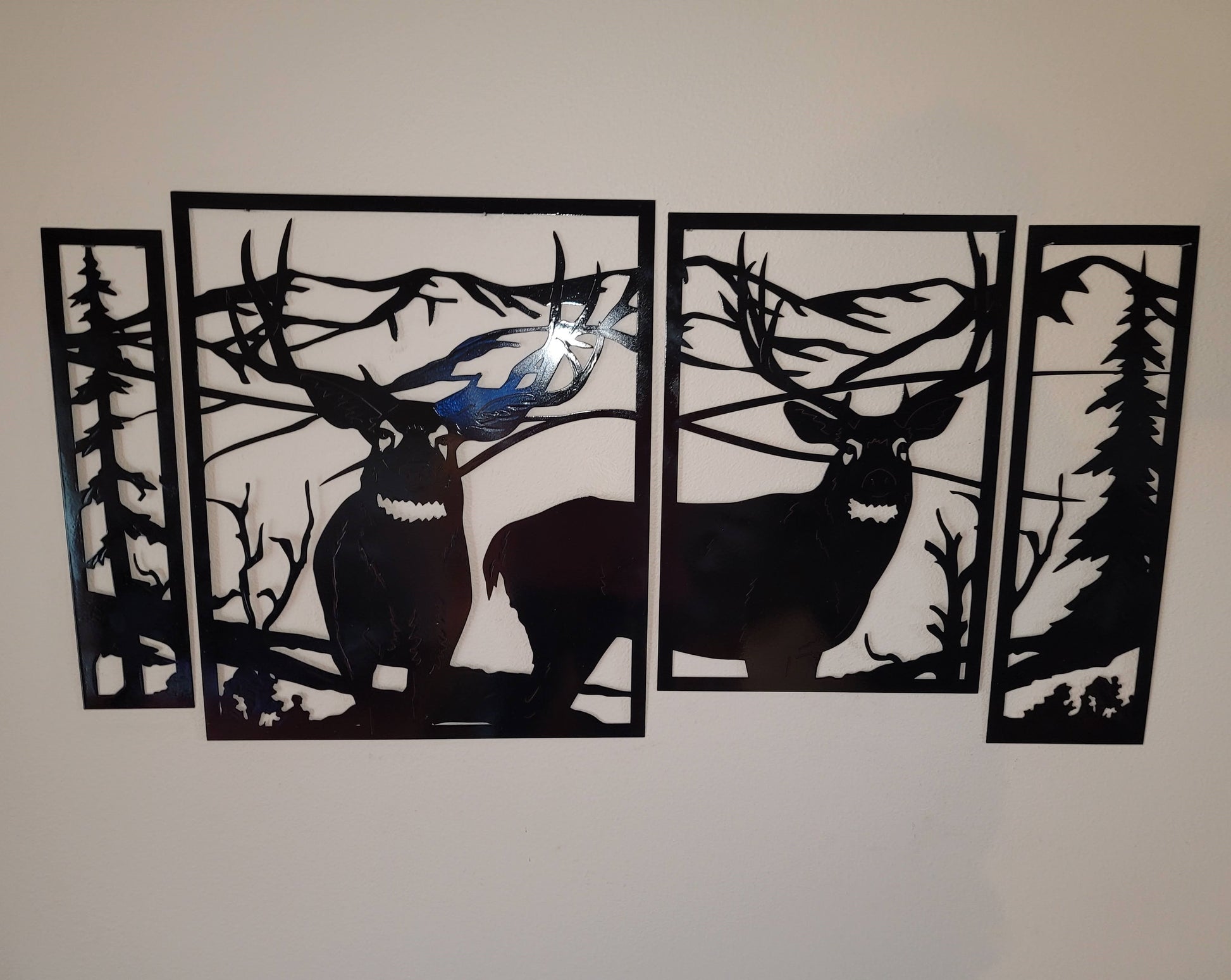 4 Panel Deer Scene. Measures 16 Inches high by 30 inches wide put together. There's four pieces. Two pieces have the deer's standing in front of a mountain scene. The two end pieces have the rest of the mountains, and a tree in each piece. Available in 4 colors, colored which is very rustic looking, black, hammer tone, and bare metal. Sprayed with a layer of varathane.layer of 