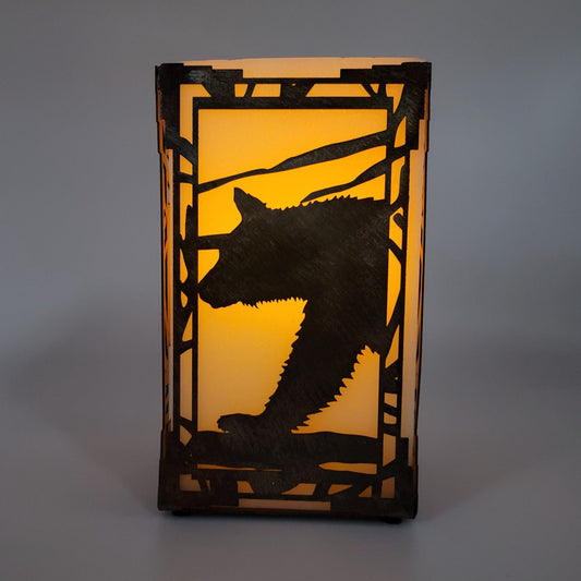 Southwest Style Bear Metal Candle Holder comes in two sizes. Medium 9" H x 5" W x 5" Deep x 18 gauge. Small measures 6" H x 4" W x 4" D x 18 gauge thick.  Available with or without the wax luminary. Ordering with the wax luminary you'll receive riser cups and battery operated tea light candle. Available in four colors; Colored-Rustic, Black, Hammer Tone, Bare Metal. This is the colored-rustic version. Sprayed with Varathane. Use only battery operated candles. Has on off switch. Battery last 40-70 hrs.