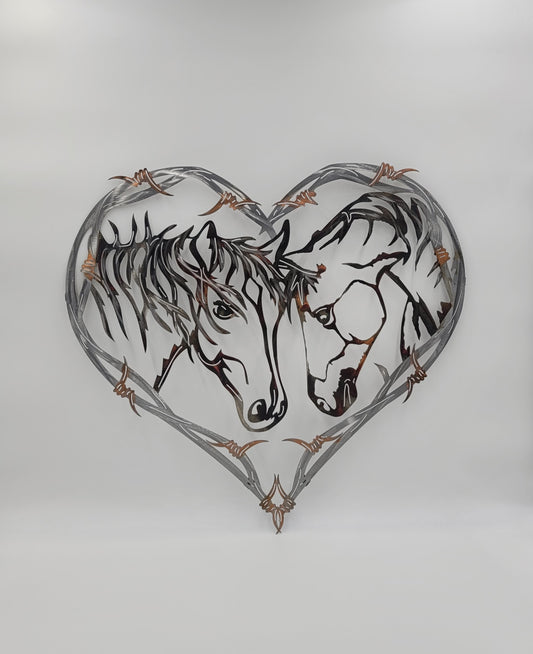 Two Horses in a Barbwire Heart Wall Hanging. It's made from 100% American made cold rolled 18-gauge sheet metal.  Measures 24 1/2 Inches High x 25 1/2 Inches Wide x 18 Gauge. Brackets on back for hanging.  Four Color Options Available; Colored-Rustic, Black, Hammer Tone, Bare Metal.