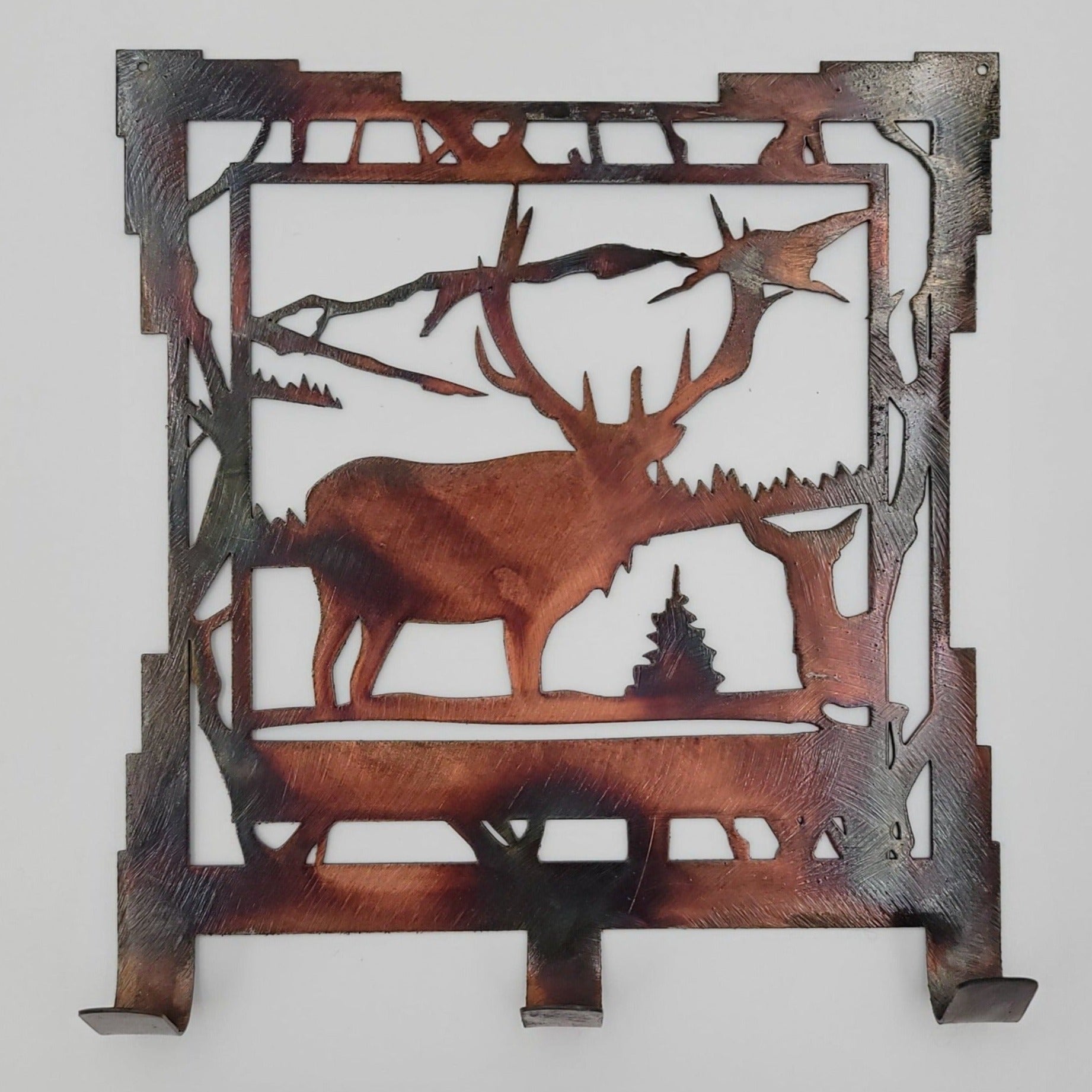 Southwest Elk Metal Key Rack. Measures 6.25 Inches Wide x 7 Inches High x 18 Gauge Thick. Three hooks for hanging keys. Holes in top corners for easy hanging. Hangs via two nails, not included. Available in four colors; Colored=Rustic, Black, Hammer Tone, Bare Metal. This one is the Colored version.