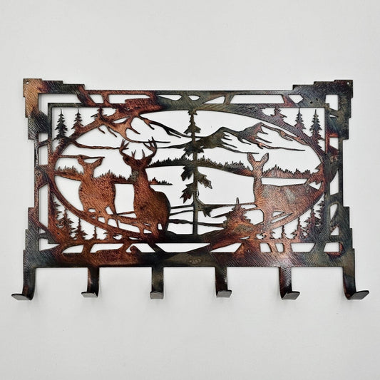 This Southwest Metal Deer Rustic Key Rack is 8" wide x 5.5" with an 18-gauge thickness. Six hooks allow for easy storage of keys, while two holes in the top corners enable easy hanging with two nails (not included). Available in four colors - Colored-Rustic, Black, Hammer Tone, and Bare Metal. This is the colored version. Coated with a thick layer of Varathane. Personalization is optional contact prior to ordering. Gift Wrapping available at checkout.